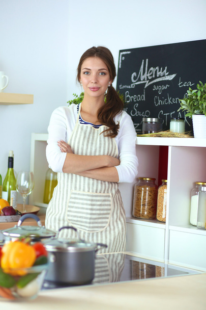 Young woman standing near desk in the kitchen - Zdjęcie, obraz