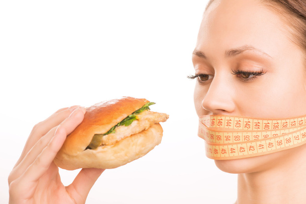 Young girl upholding a burger. - Photo, image