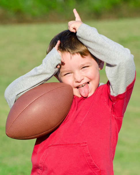 Young boy playing with football - Fotó, kép