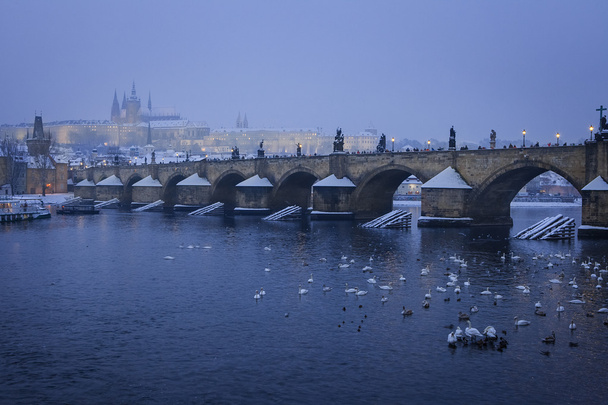 Romantic Snowy Prague gothic Castle with the Charles Bridge, Czech Republic - Photo, Image