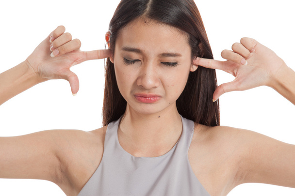 Young Asian woman block both ears with fingers - Foto, Bild