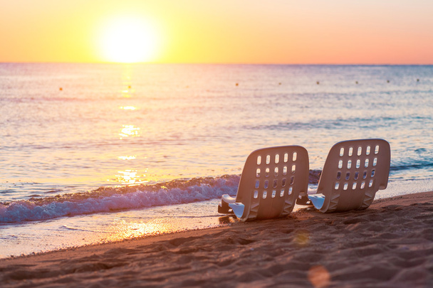 Landscape of Two Lonely beachchairs near sea and beautiful sunrise - Photo, Image