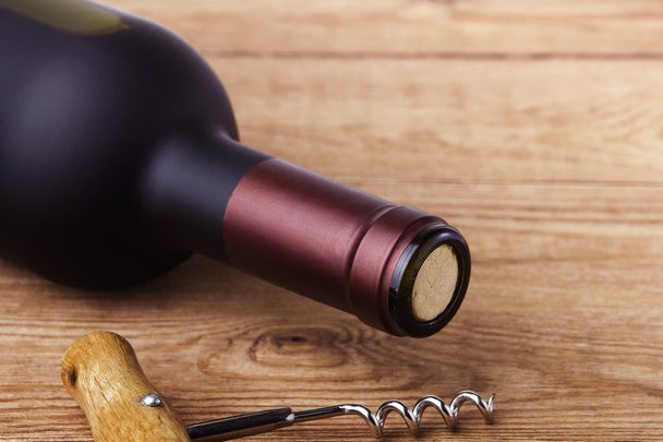 Corkscrew and bottle of wine - Photo, Image