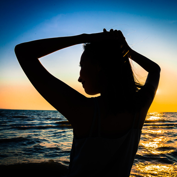 Silhouette young woman on beach - Photo, Image