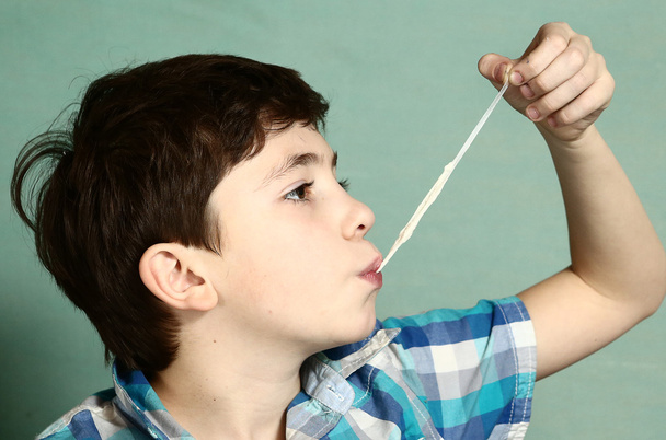  chico tire de goma de mascar con su mano de la polilla
 - Foto, Imagen