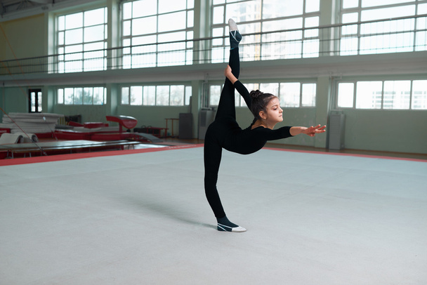  gymnast performs a balance with split. - Fotoğraf, Görsel