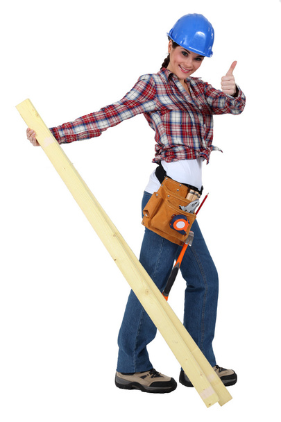 A female carpenter giving the thumb up. - Фото, зображення