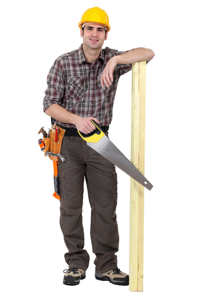 Casual carpenter stood with wood - Foto, afbeelding
