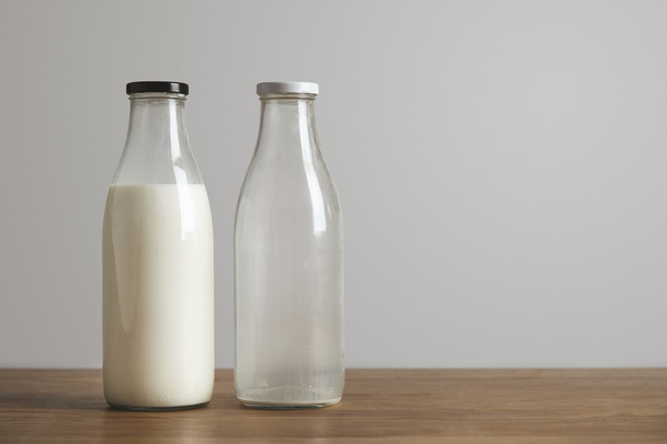 Simple vintage bottles with fresh milk and empty - Photo, Image