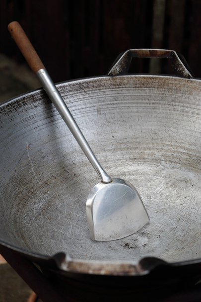 Empty big pan and scoop or flipper used in frying. - Foto, immagini