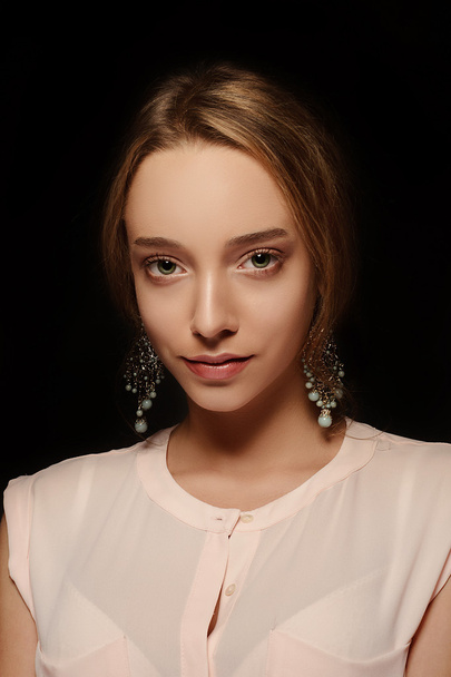 Portrait of beautiful girl with nude make-up. Girl in a beautiful jewelry - Фото, изображение