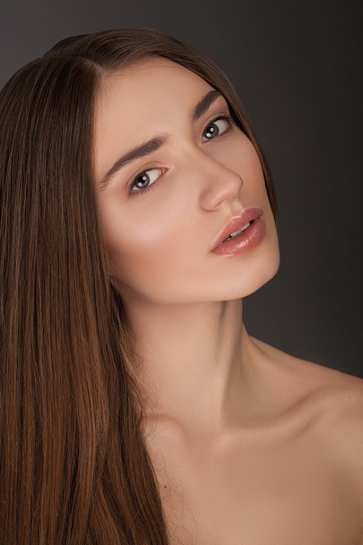 Closeup portrait of beautiful  young brunette woman with natural makeup, face skin treatment, enjoying day spa - 写真・画像