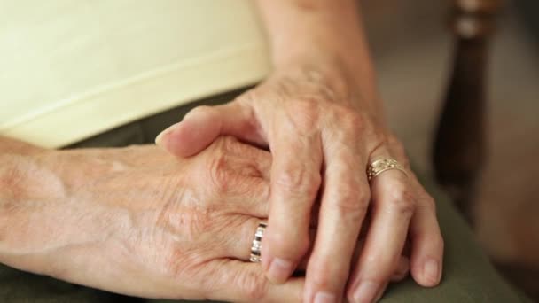 A close up shot of an elderly woman holding hands together. - Video, Çekim