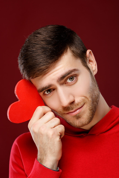 Man holding a red heart close up. - Фото, зображення