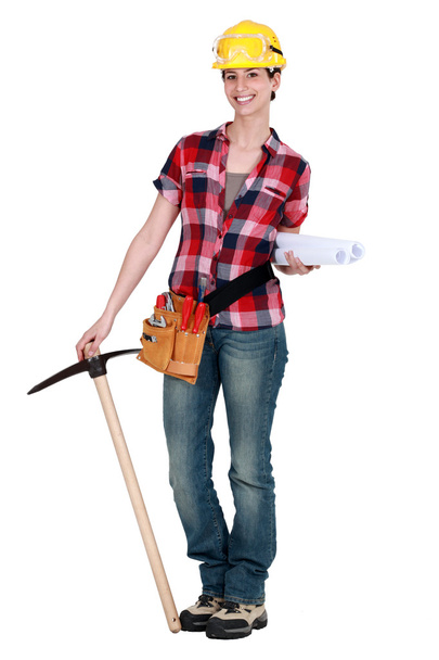 Woman with a pickaxe and plans - Фото, изображение