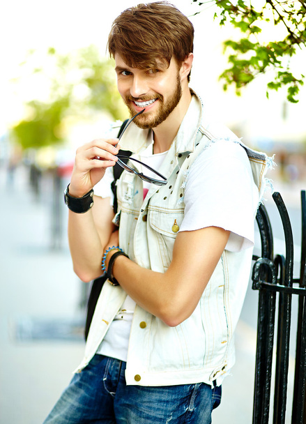 Funny smiling hipster handsome man guy in stylish summer clothes in the street - Fotoğraf, Görsel