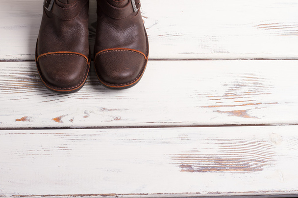 Boots on a wooden background. - Foto, afbeelding