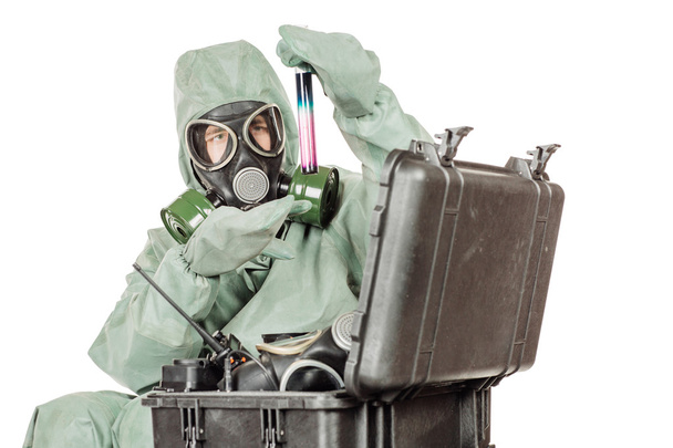Man with protective mask and protective clothes prepares equipment for work - Foto, imagen