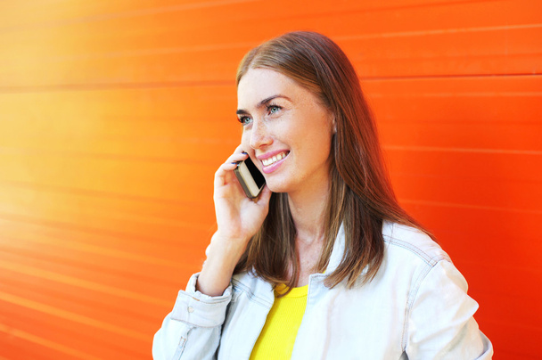 Portrait happy pretty smiling woman talking on smartphone over c - Photo, Image