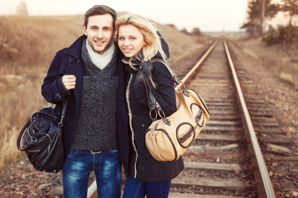 girl and man posing on rail road - Valokuva, kuva