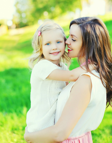 Portrait happy mother hugging child daughter in summer day - Photo, image