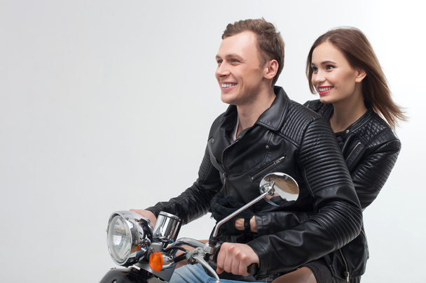 Cheerful boyfriend and girlfriend on motor bike - Fotó, kép