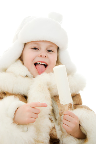 The girl in warm clothes eating ice cream on white background. - Foto, Imagem