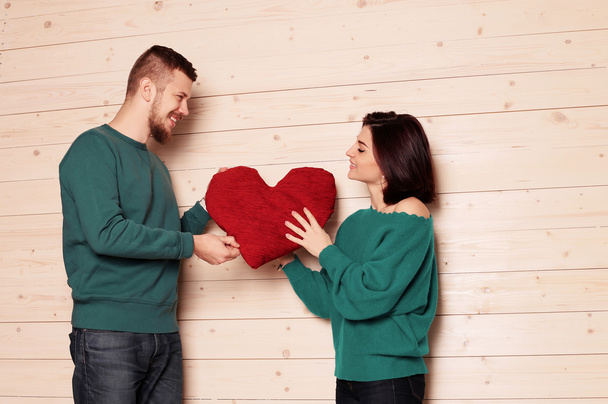 Tender couple holding red heart - Foto, imagen