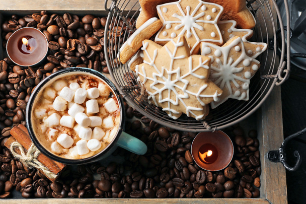 Mug of hot cacao with marshmallow and cookies on coffee beans - Photo, image