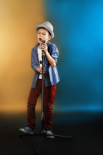 Little boy singing with microphone  - Valokuva, kuva