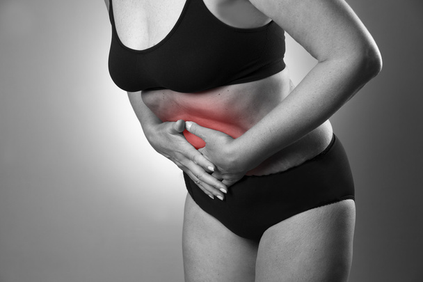 Woman with abdominal pain. Pain in the human body - 写真・画像