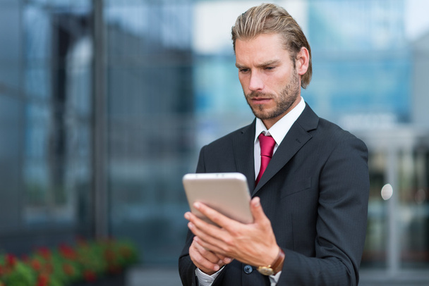 Businessman using his tablet - Фото, изображение