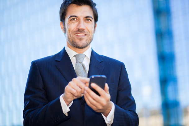 businessman holding mobile phone - Fotó, kép