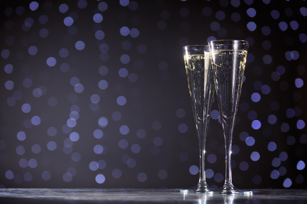 Two glasses of champagne on dark bokeh background - Φωτογραφία, εικόνα
