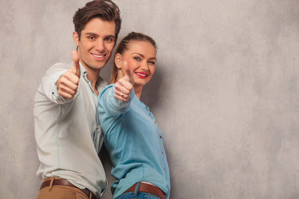 man with his girlfriend posing in studio showing thumbs up  - Photo, Image