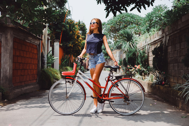 girl posing with  vintage bicycle - 写真・画像