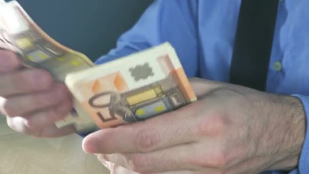 Businessman counting fifty euros banknotes in office - Felvétel, videó