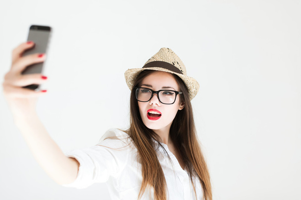 girl with red lips posing in glasses - 写真・画像