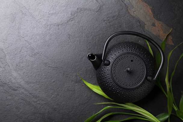 Asian teapot over stone table - Fotoğraf, Görsel