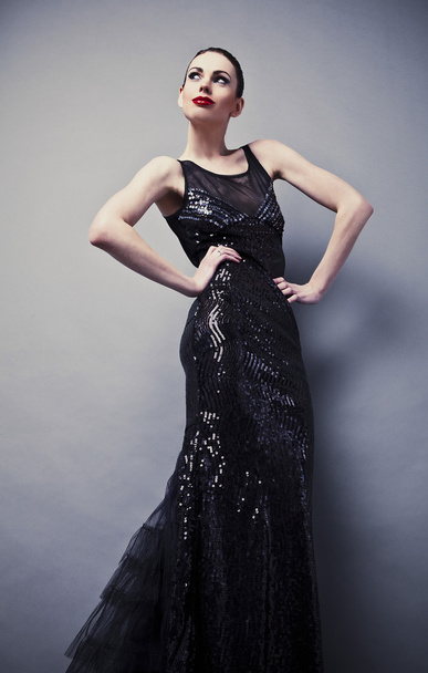 Beautiful woman on black classical dress pose in studio. - Valokuva, kuva
