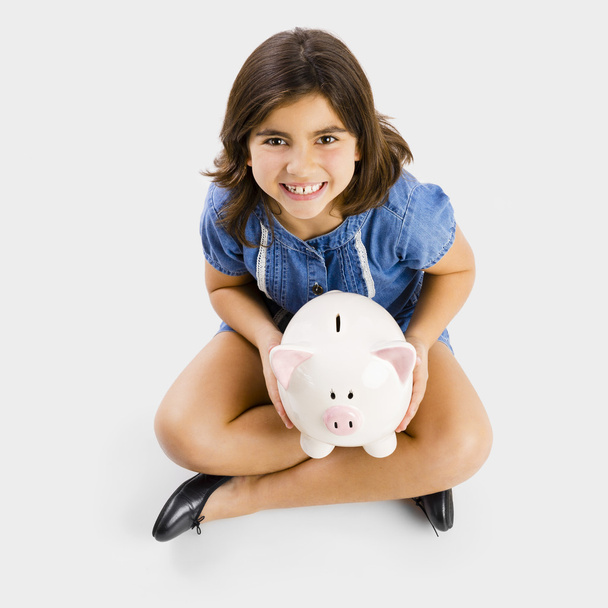 Young girl holding a piggy bank - Foto, immagini