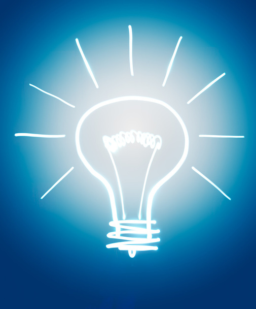 Light bulb isolated on dark blue - Photo, Image