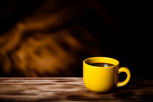 Coffee in cup on wooden table opposite a blurred background. Ton - Fotó, kép