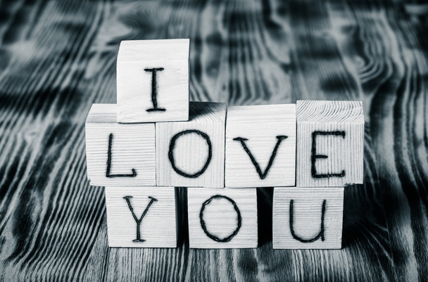 Wooden cubes with inscription "I LOVE YOU" on new wooden backgro - Foto, Imagen