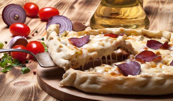 Prepared pizza with smelted cheese. Selective focus - Foto, afbeelding