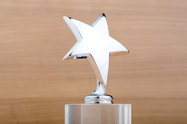 Star award against wooden background - Foto, afbeelding