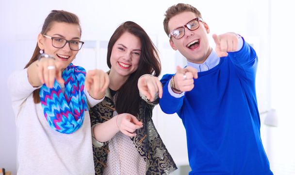 Young business people standing at office near desk and showing ok - Foto, Imagem