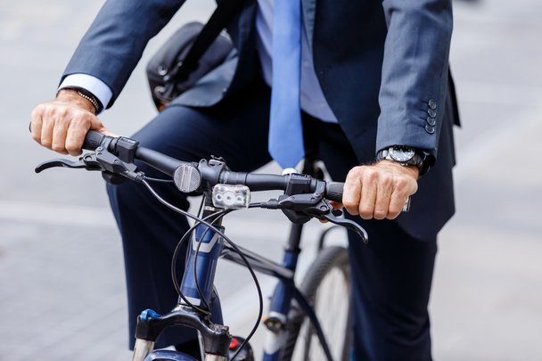 Successful businessman riding bicycle - Photo, image