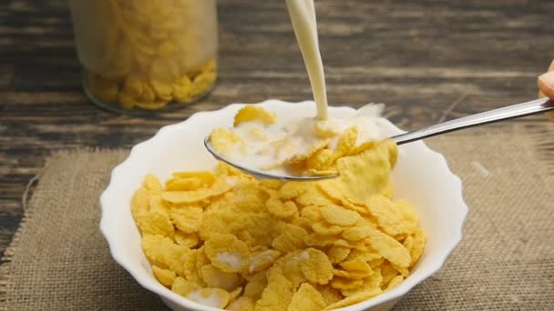 fresh milk pouring into a bowl full of cornflakes in slowmotion - Footage, Video