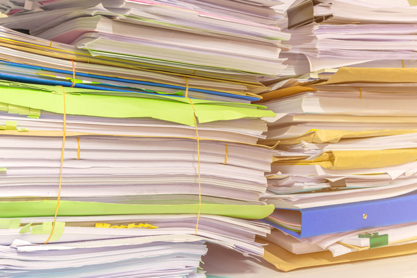 Pile of documents on desk stack up high waiting to be managed - Photo, Image